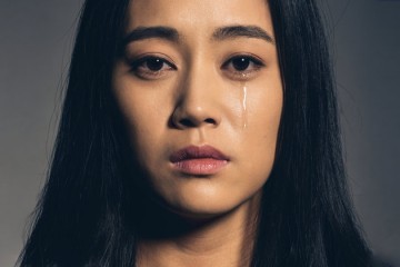 Portrait of Chinese young woman crying.